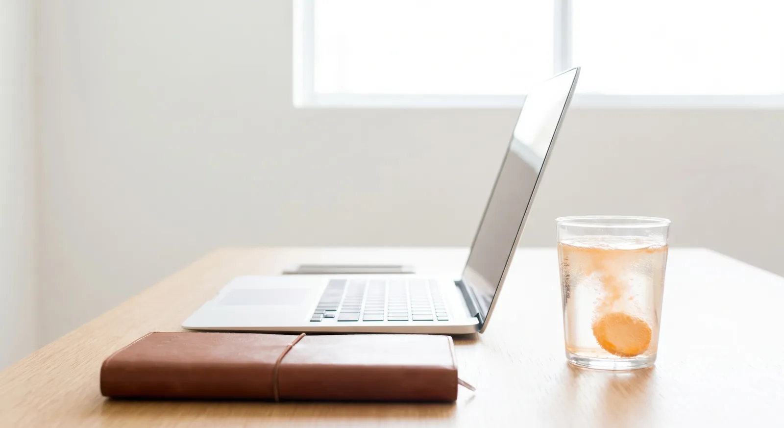 A workspace with notebook and supplements